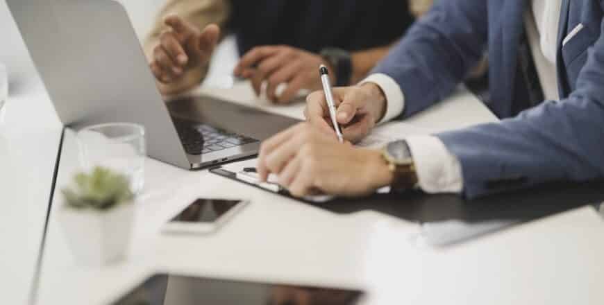 Office workers checking papers with pen in office