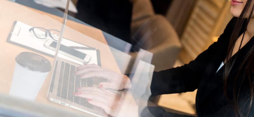 brunette-businesswoman-through-window-with-laptop