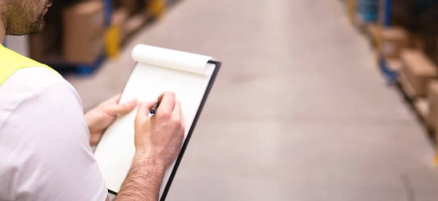 factory-worker-holding-clipboard-checking-inventory-warehouse-storage-department