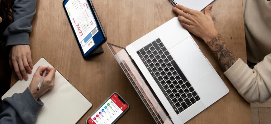 man-woman-working-together-from-home-desk