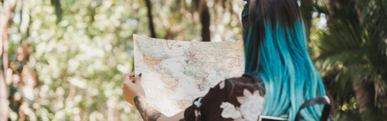 rear-view-young-woman-searching-destination-map