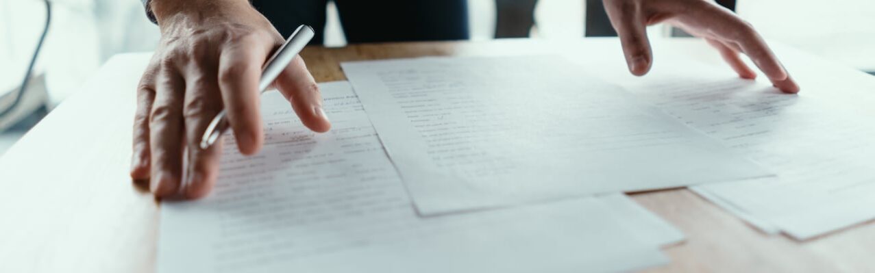 successful-business-man-signing-documents-modern-office.jpg