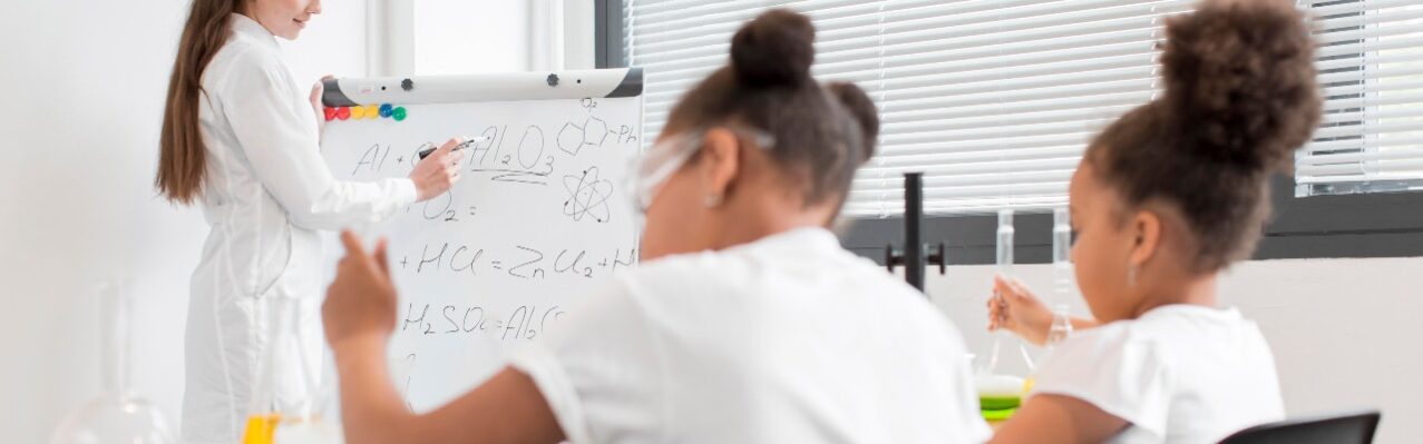 young-girls-learning-about-chemistry-from-female-scientist.jpg