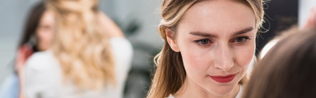 female-visagiste-putting-makeup-client.jpg