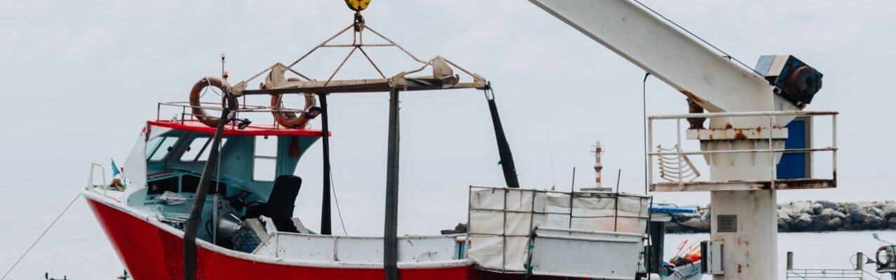 vertical-shot-crane-lifting-white-boat-pier.jpg