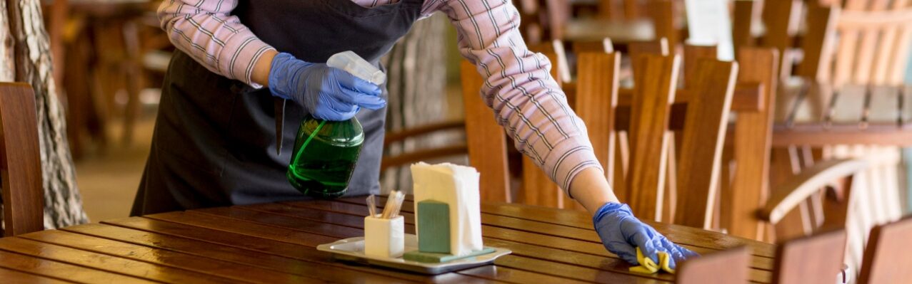 woman-with-face-protection-cleaning-tables.jpg