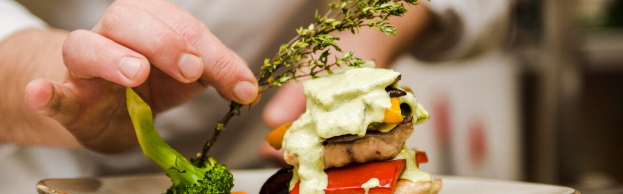chef-placing-herb-gourmet-meal.jpg