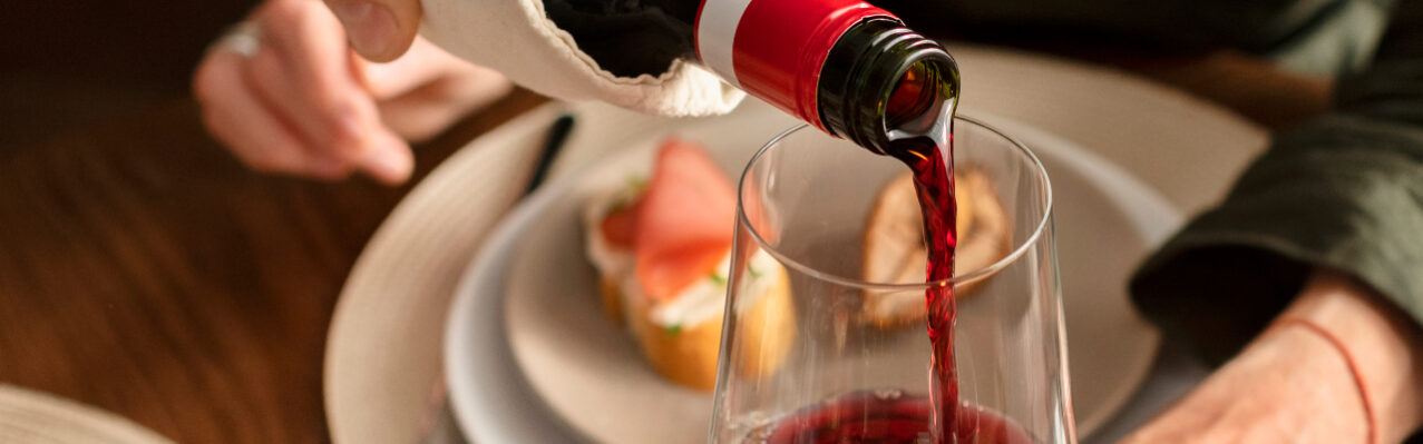 close-up-hand-pouring-wine.jpg