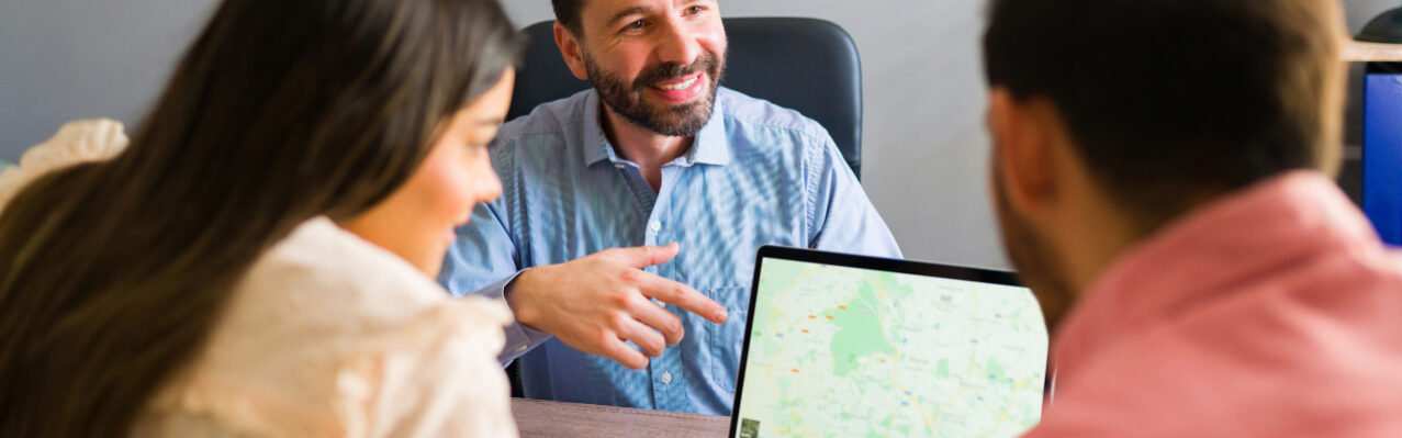 here-is-your-trip-destination-rear-view-beautiful-couple-looking-map-laptop-travel-agency-choosing-where-go-vacation.jpg