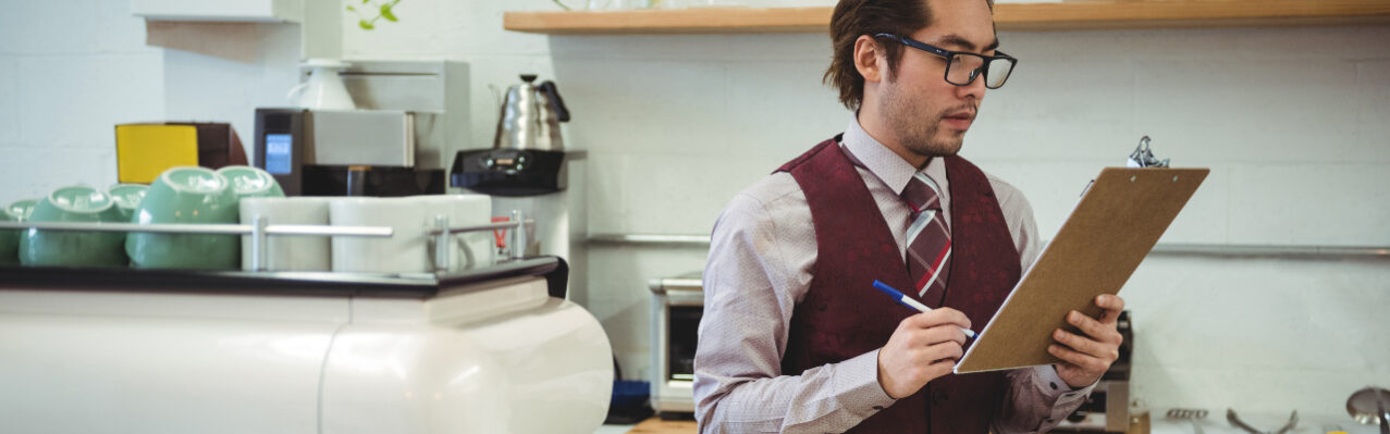 man-writing-with-pen-clipboard.jpg