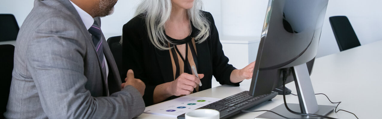 mentor-helping-intern-workplace-colleagues-watching-content-pc-monitor-sitting-table-with-paper-diagram-business-communication-concept.jpg