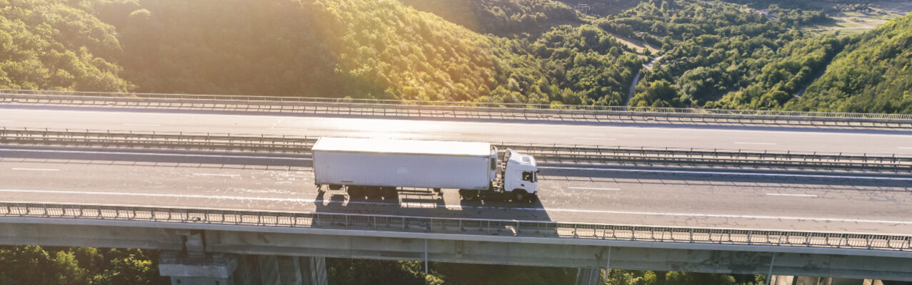 trucks-highway-mountain-sunset.jpg
